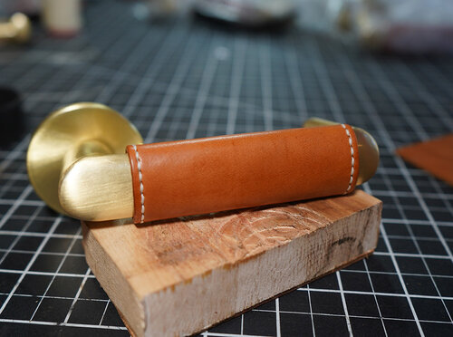 Outside of the leather wrapped door handle with finished stitching