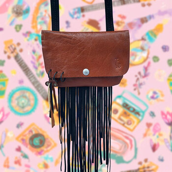 Woman's bag with a western and Topanga flair - tassels and buffalo design snap