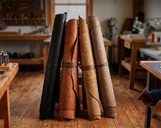 Leather rolls leaning against a table inside a leather studio